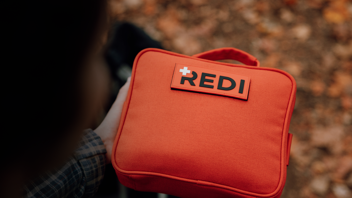 The Roadie readiness kit, an orange car emergency kit with first aid, mounted in a vehicle