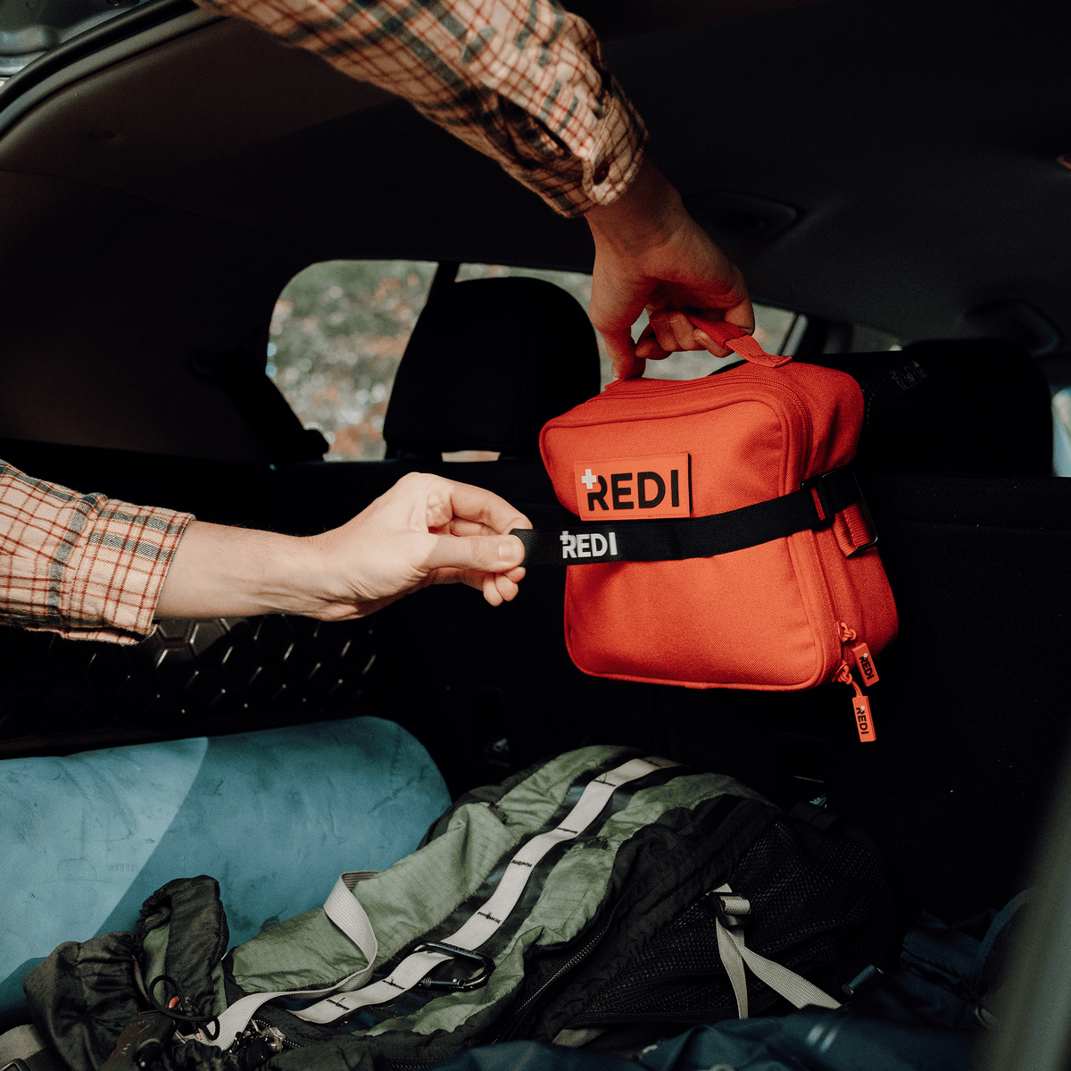 Strapping The Roadie car emergency kit to the back of a car seat with its Velcro headrest strap