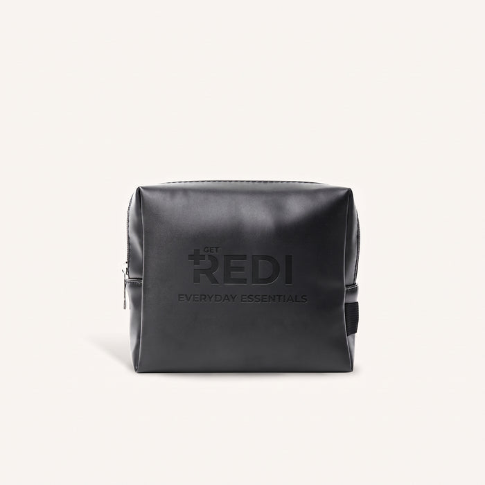 REDI Everyday Essentials Bag, a black PU leather zippered travel kit with embossed logo