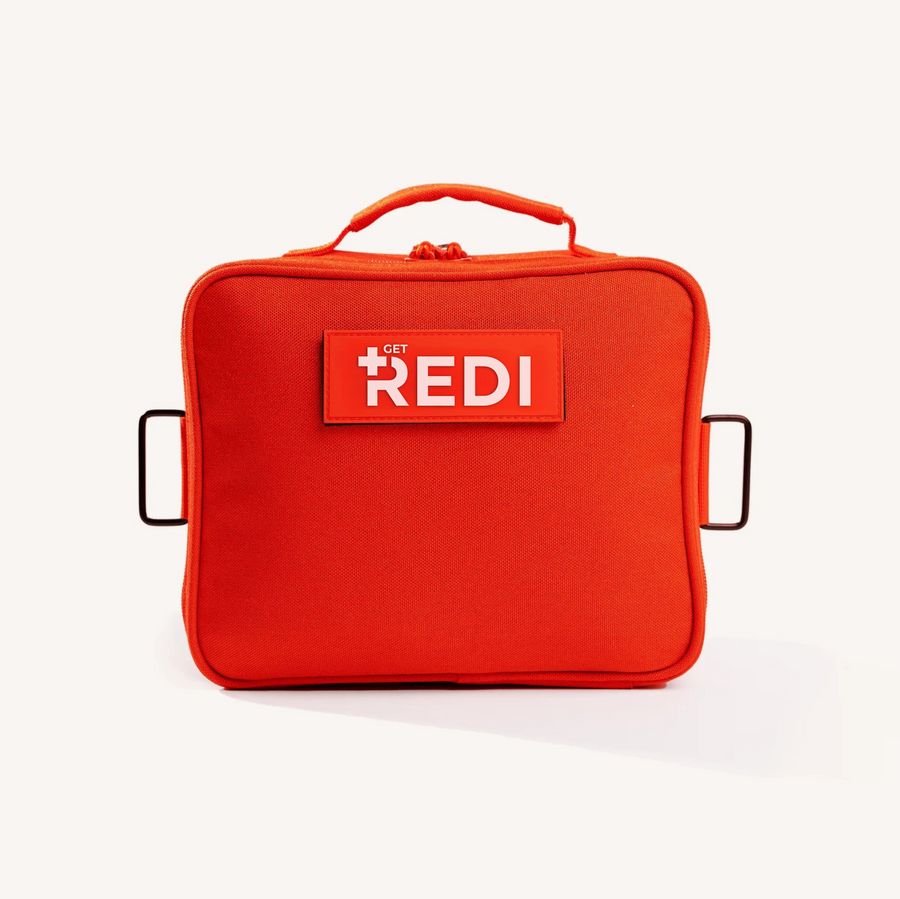 The Roadie car emergency kit, a bright orange 1000D Cordura readiness kit bag with REDI logo